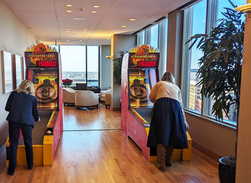 People playing Fireball Fury Skee-Ball game at a company event